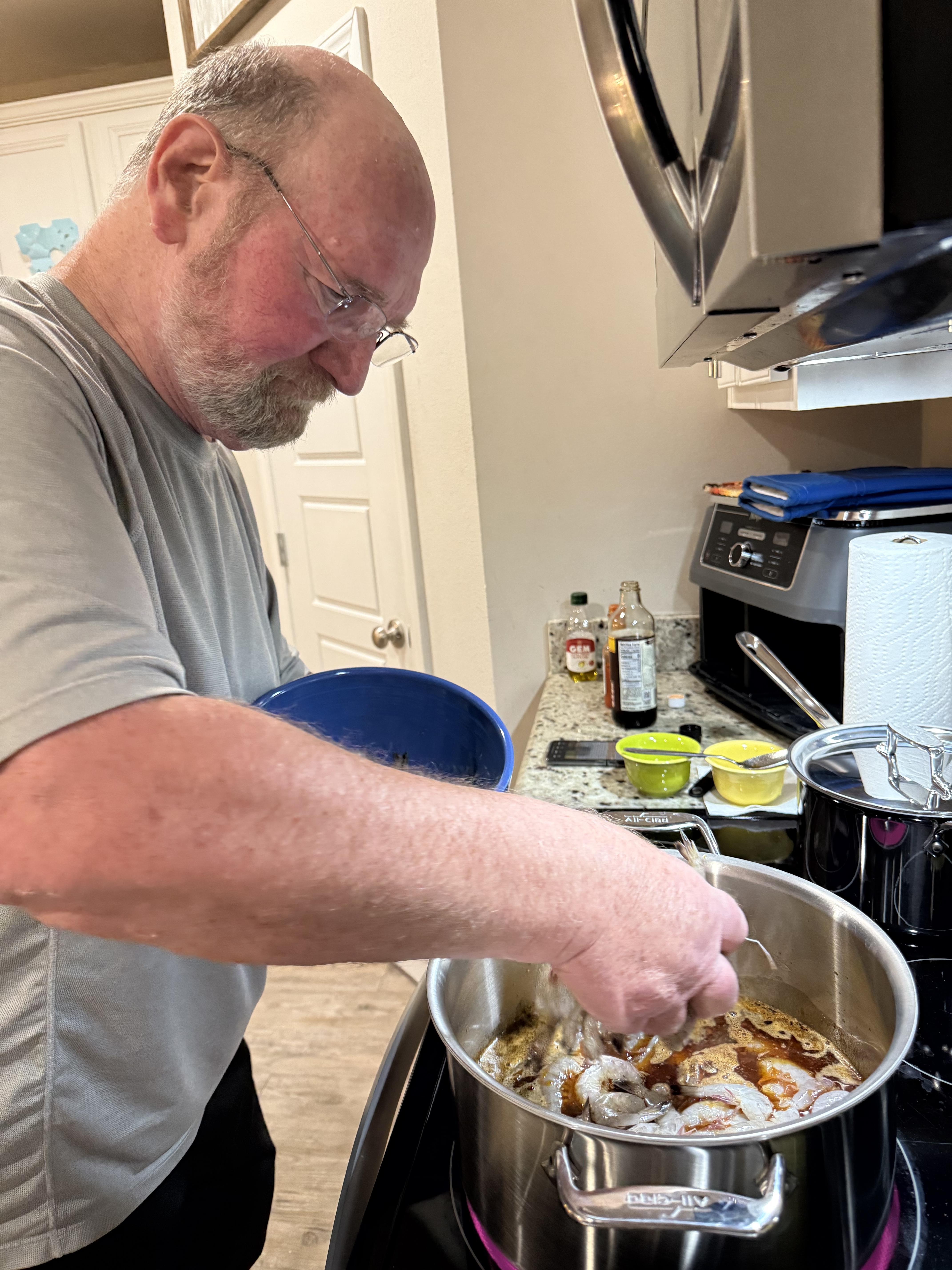 A man cooking food in a pot