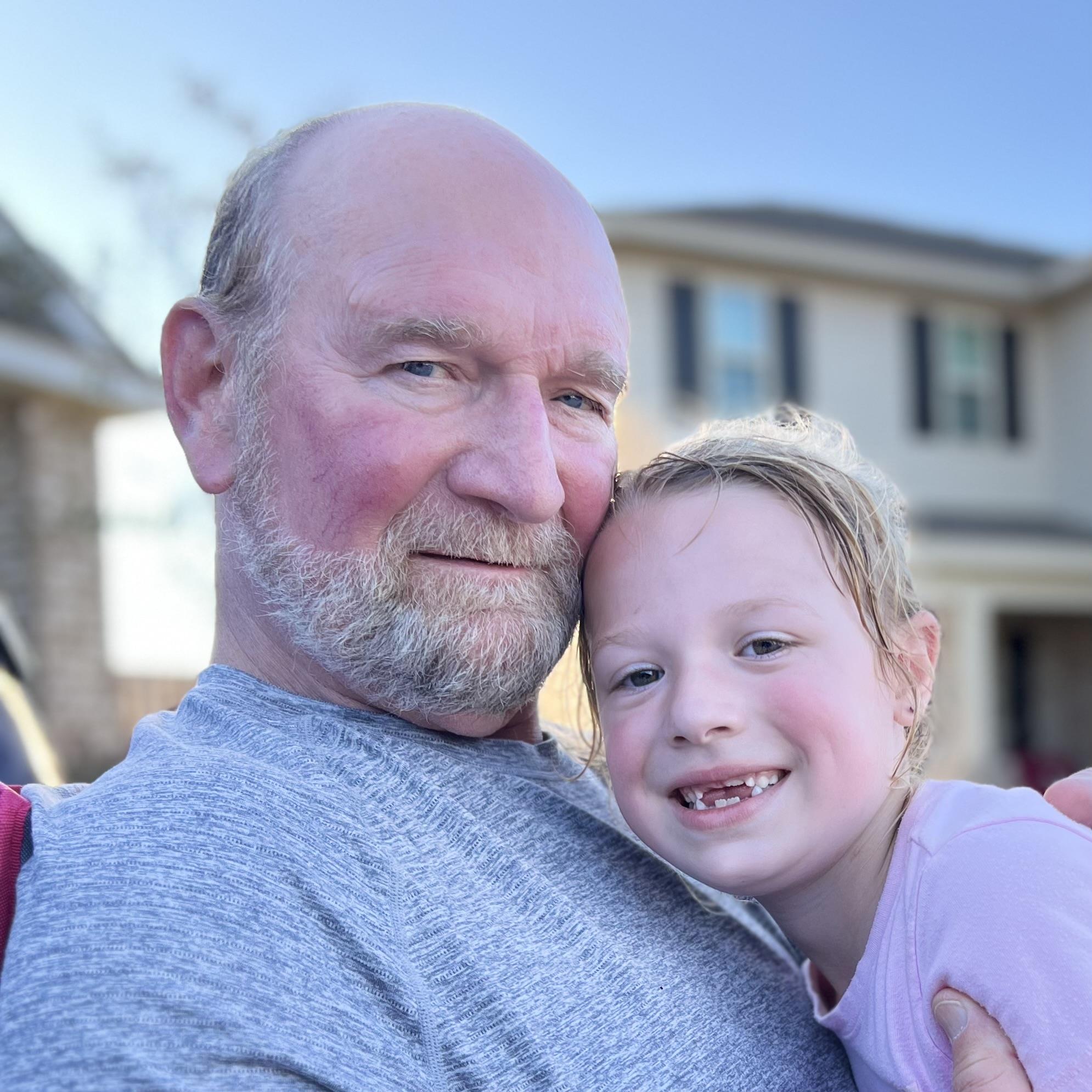 A man and a child posing for a picture