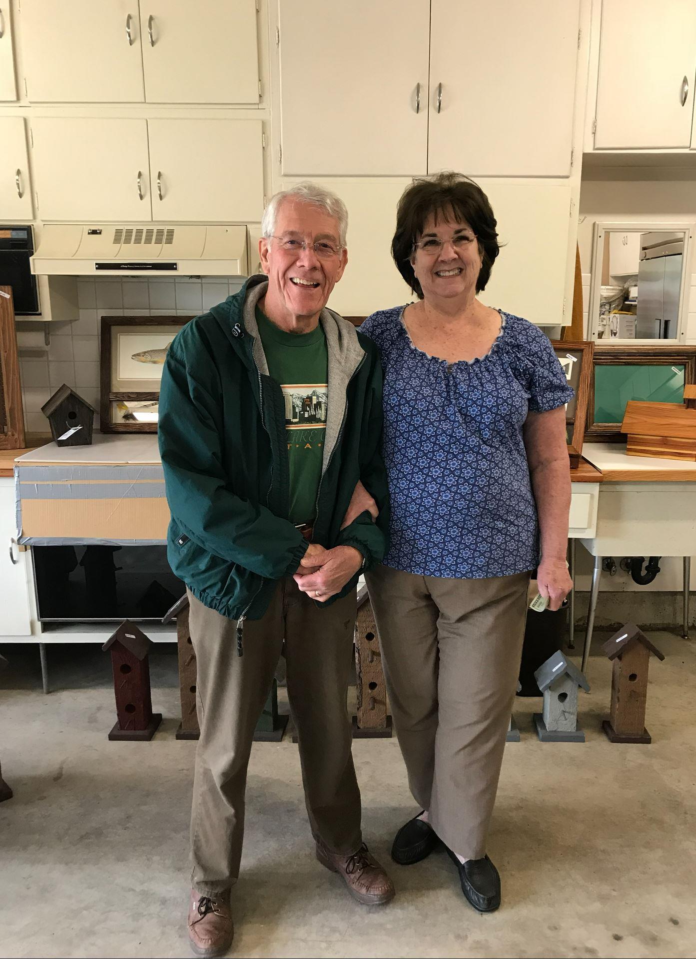 A man and woman standing in a kitchen