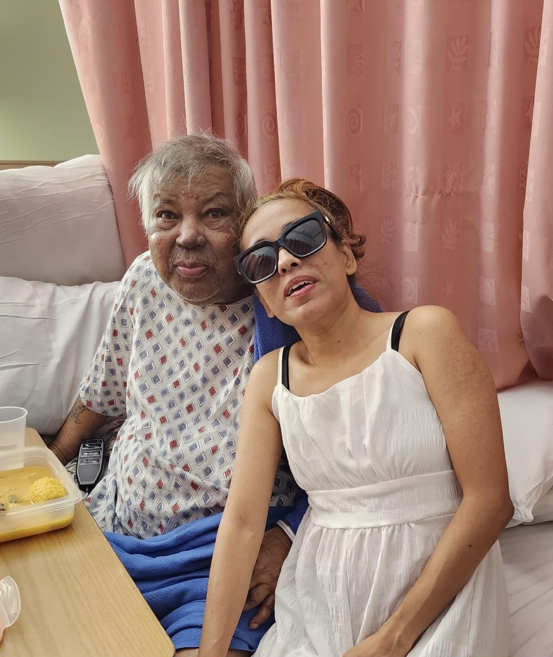 A woman wearing sunglasses and sitting next to a woman wearing sunglasses