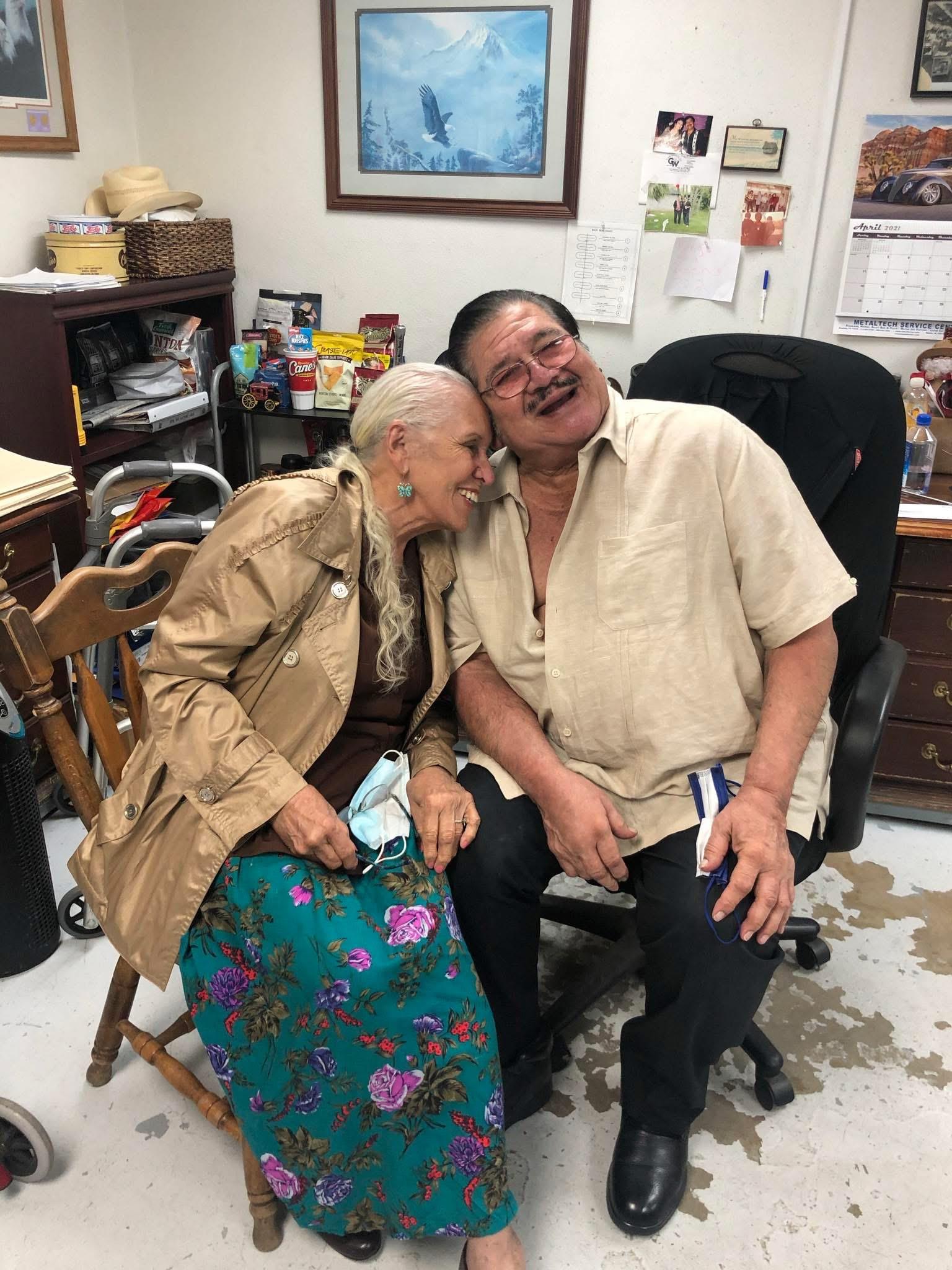 A man and woman sitting in a chair