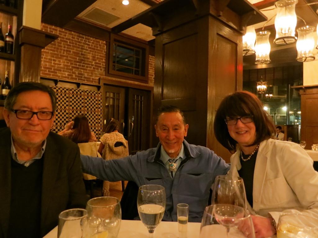 A group of people sitting at a table with wine glasses