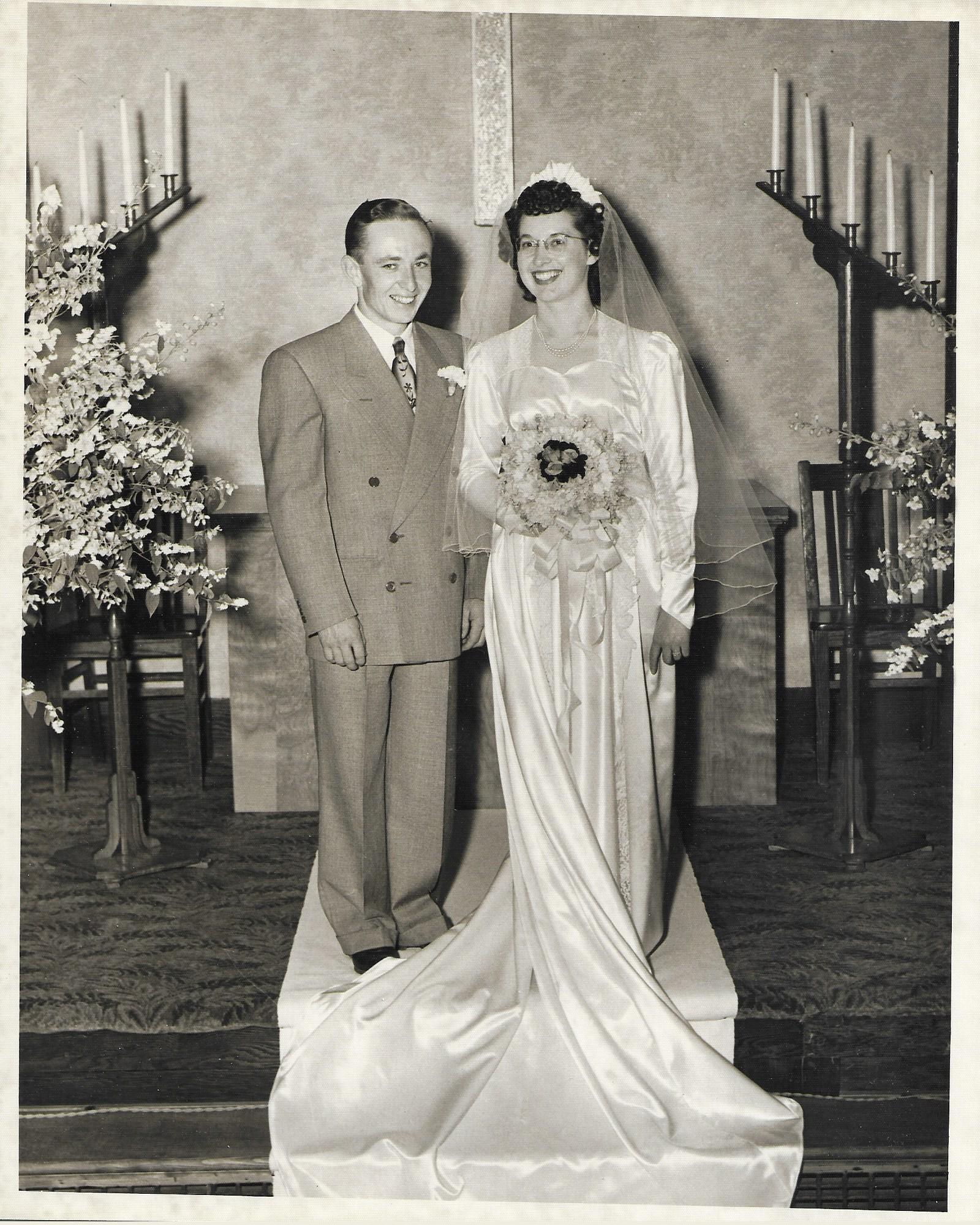 A man and woman standing on a carpet