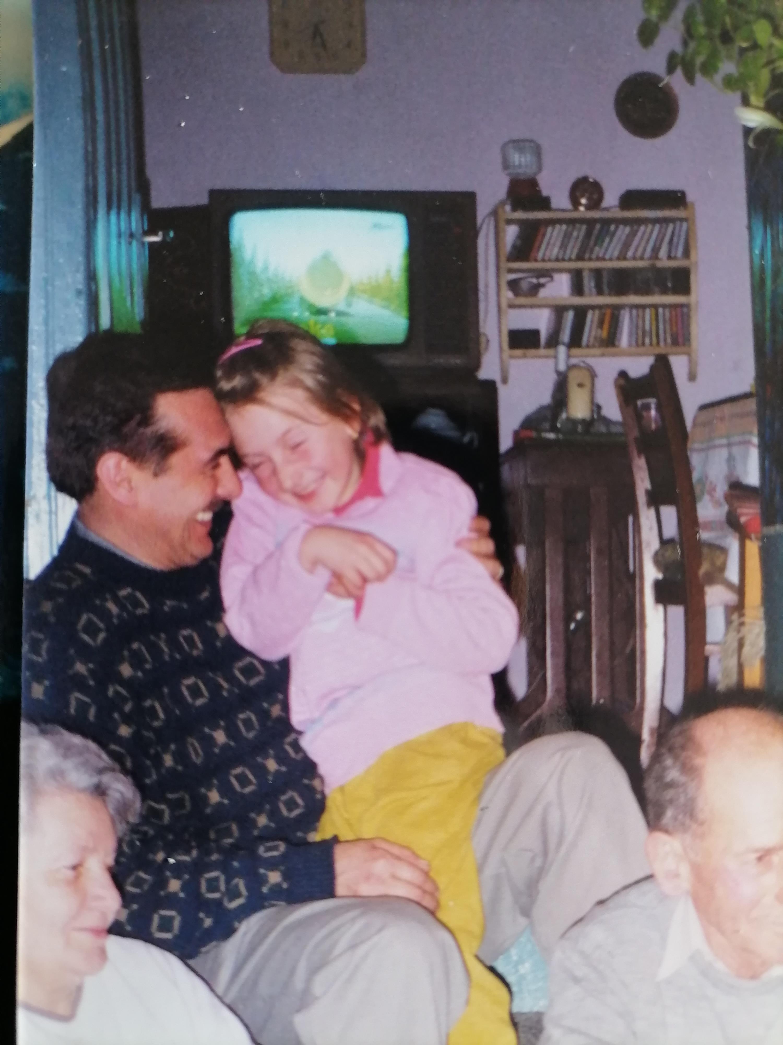 A man and a girl sitting on a couch