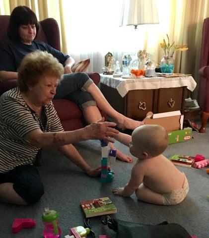 A woman and baby playing with toys