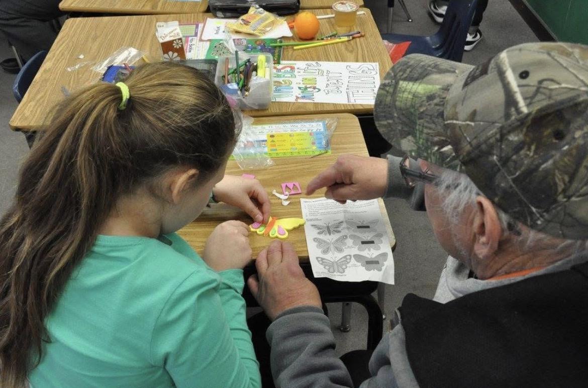 A man and woman working on a craft