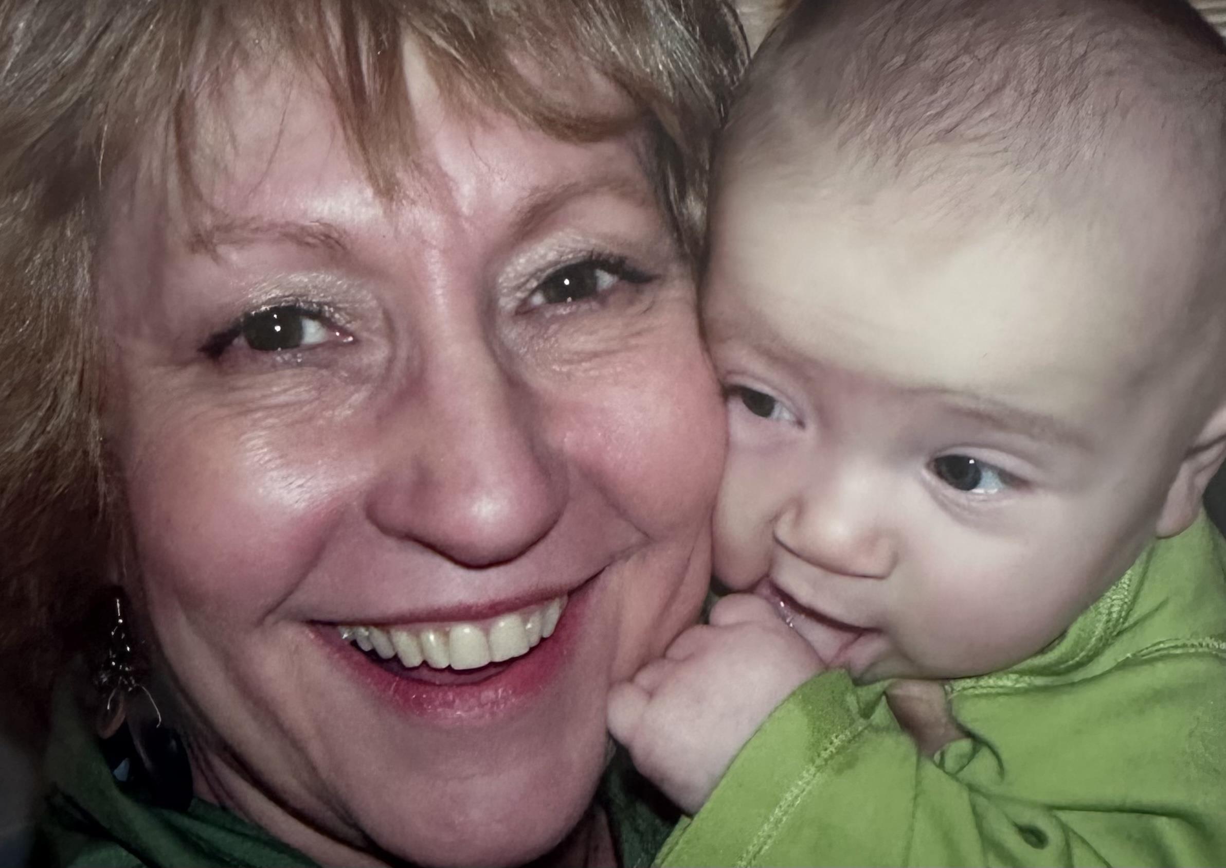 A woman smiling with a baby