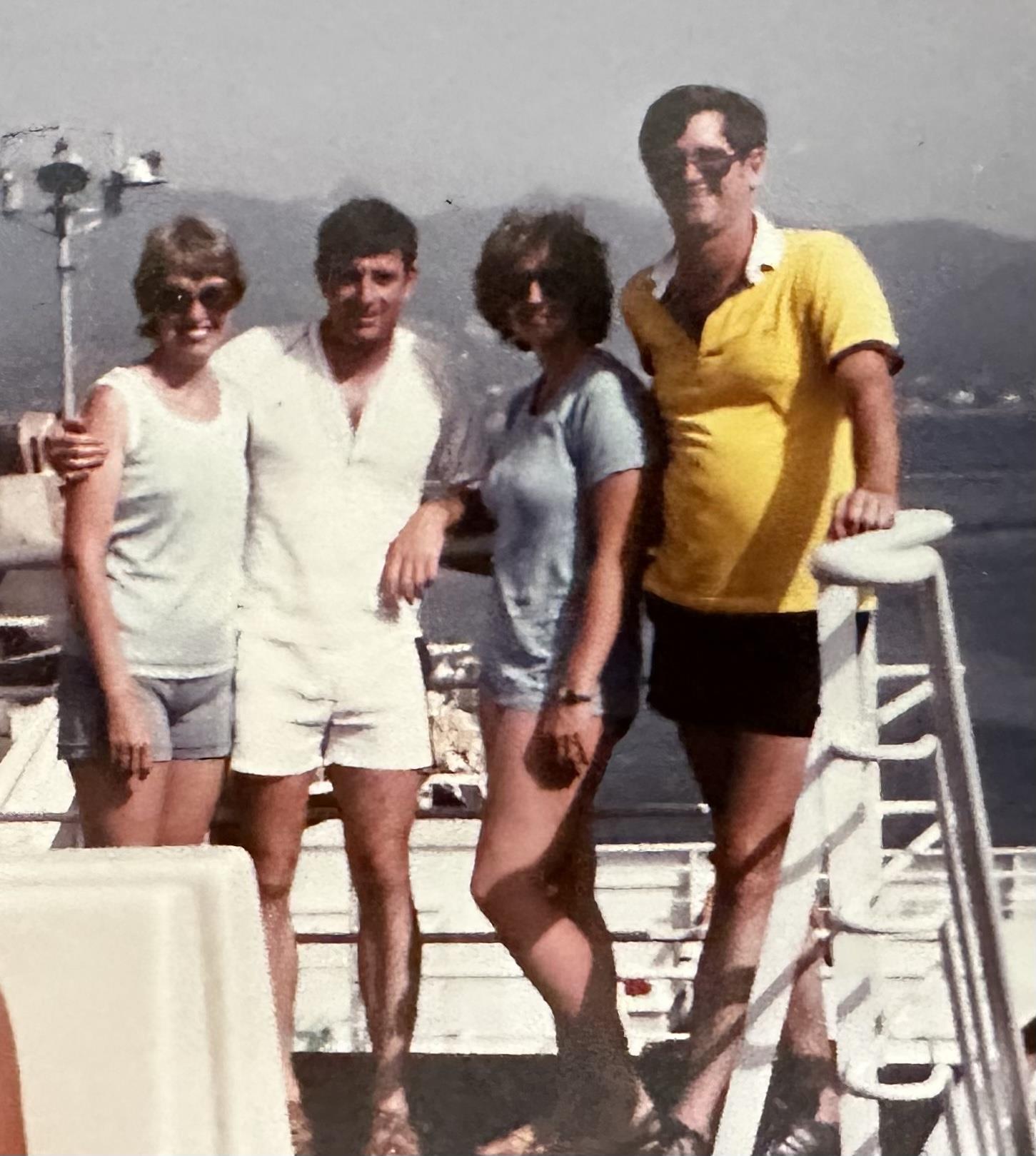 A group of people posing for a photo on a boat