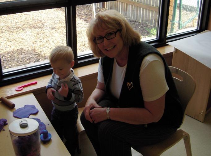 A woman sitting with a baby