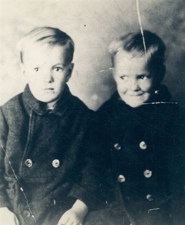 A couple of young boys in black coats