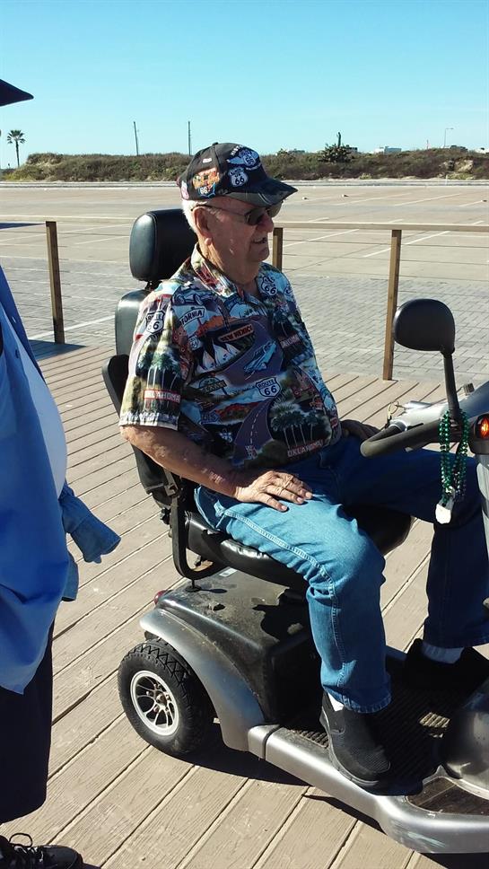 A man sitting on a scooter