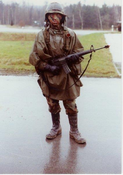A man in a raincoat holding a gun