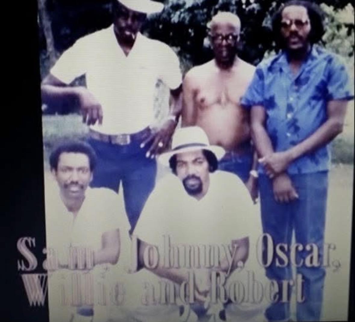 A group of men posing for a photo