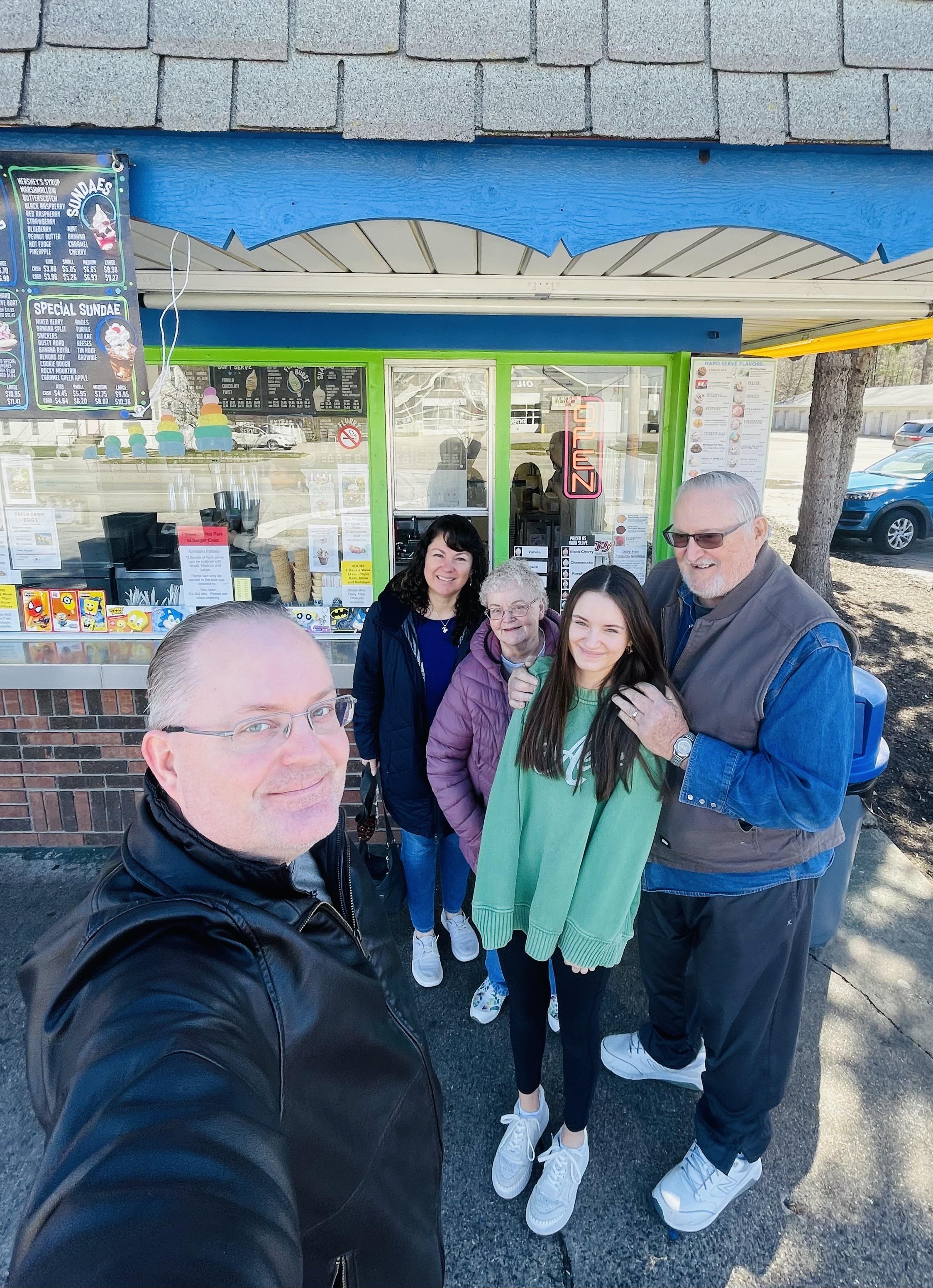 A group of people standing outside a store