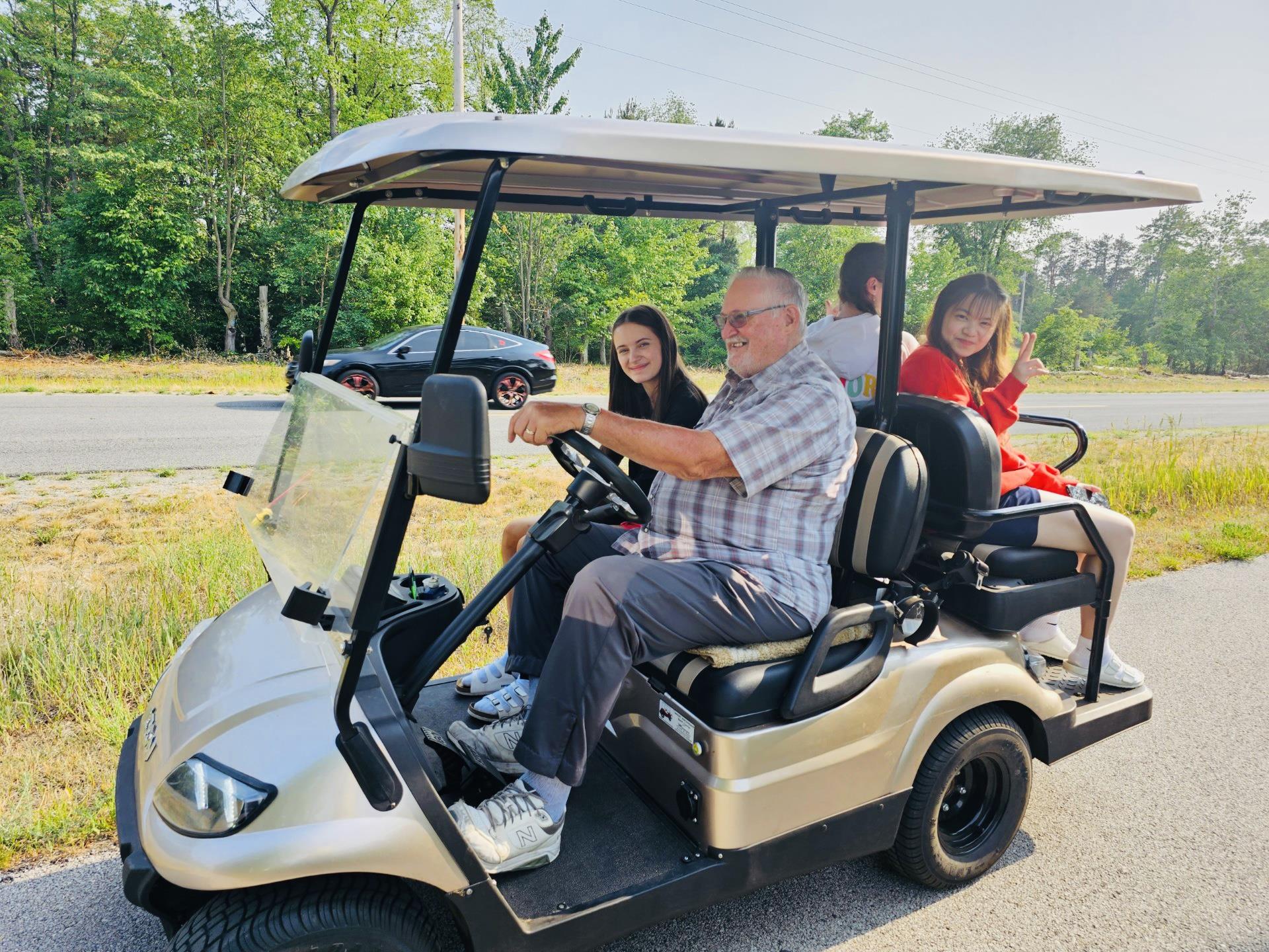 A group of people in a golf cart