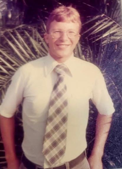 A man wearing a tie and glasses