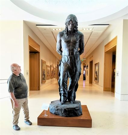 A man looking at a statue
