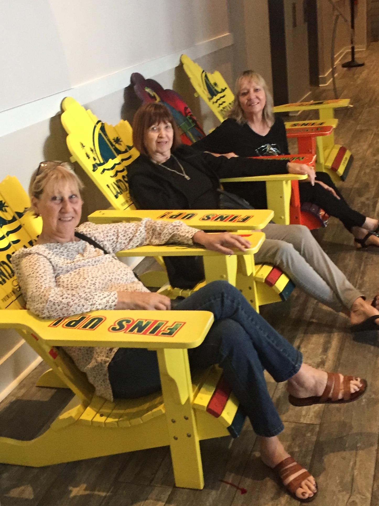 A group of women sitting in yellow chairs