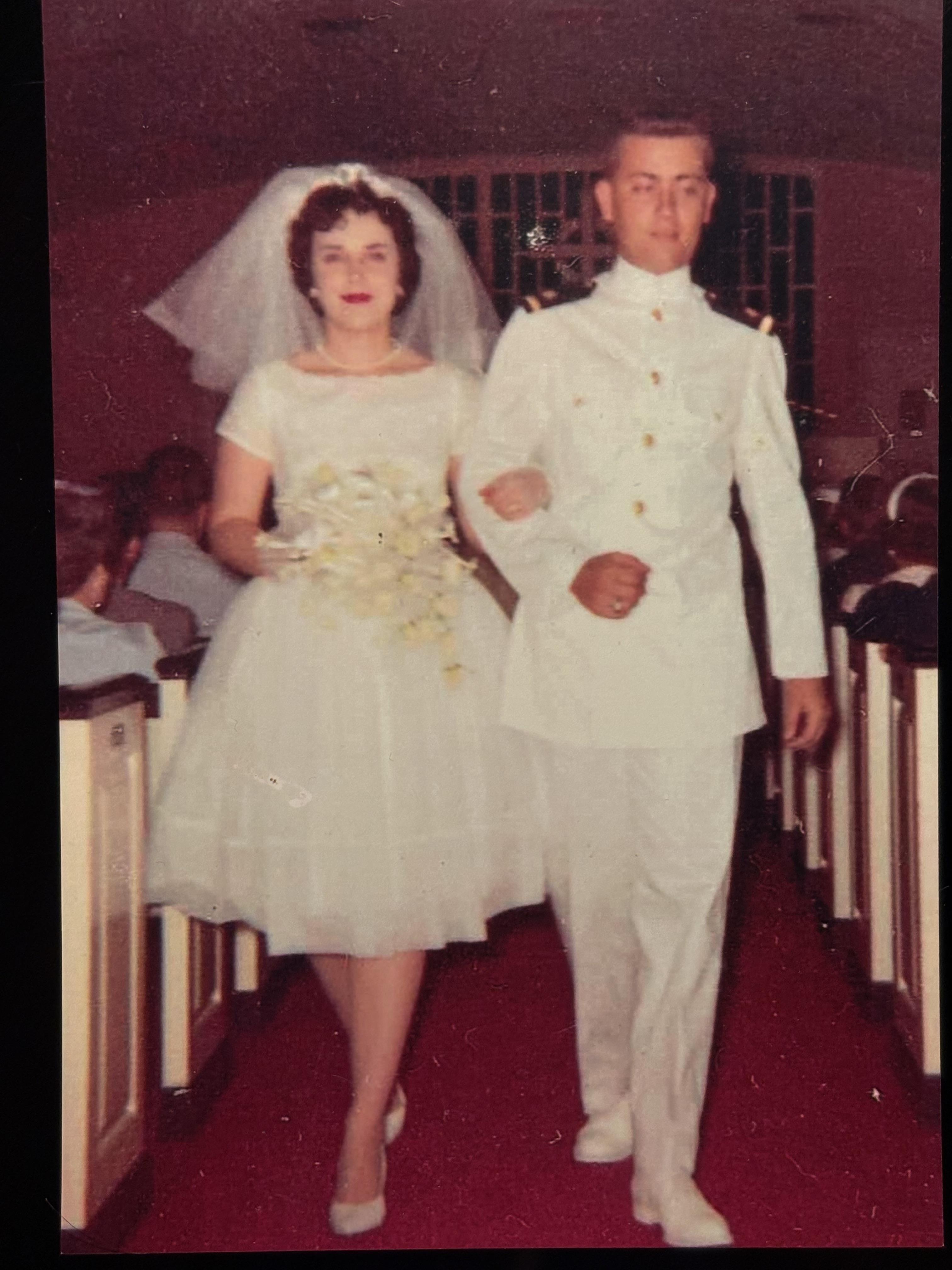 A man and woman in white wedding attire