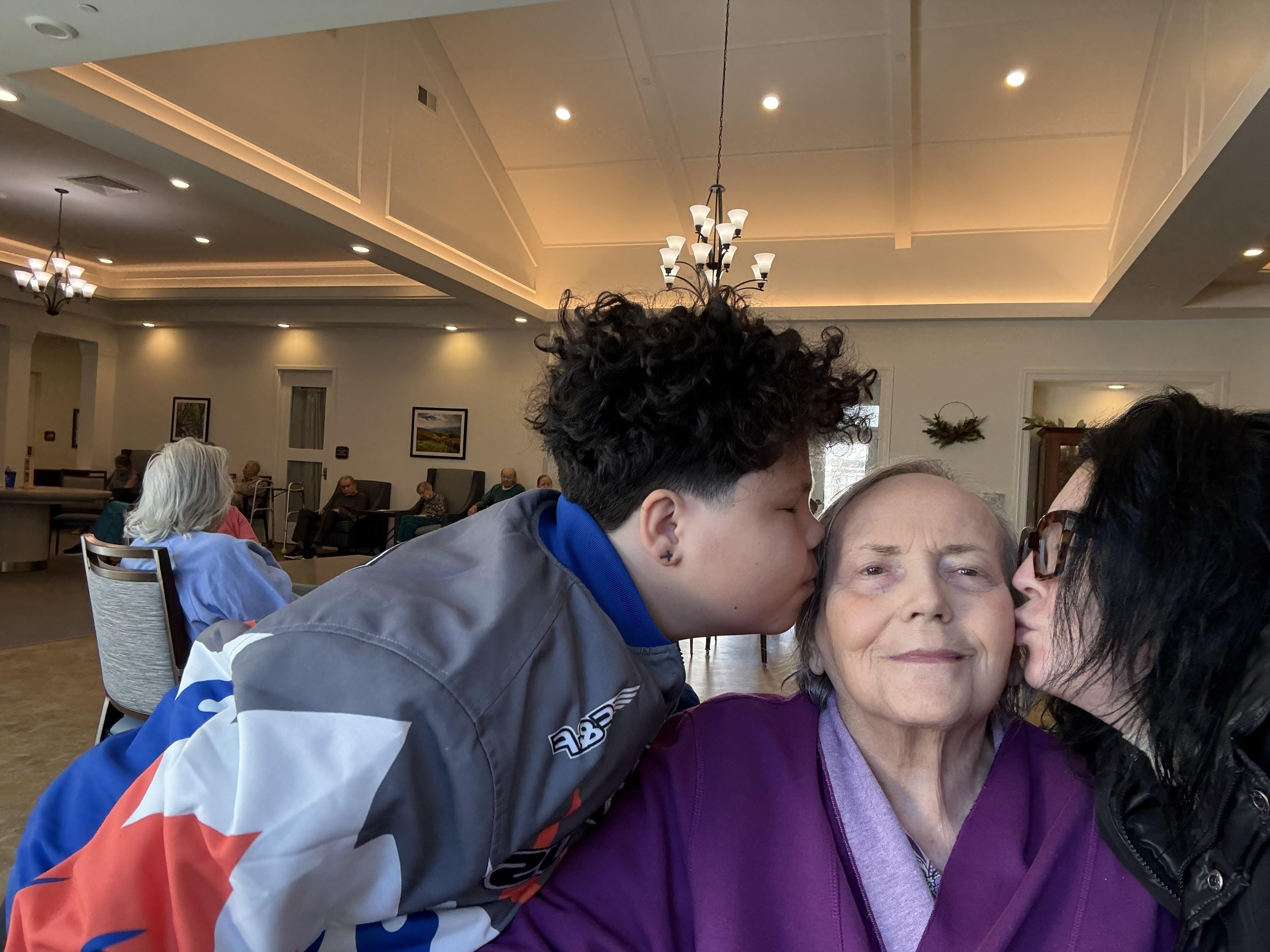A group of people kissing on the cheek