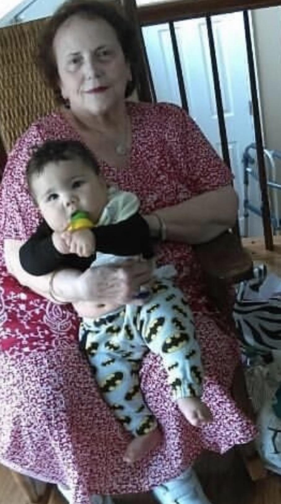 An old woman holding a baby