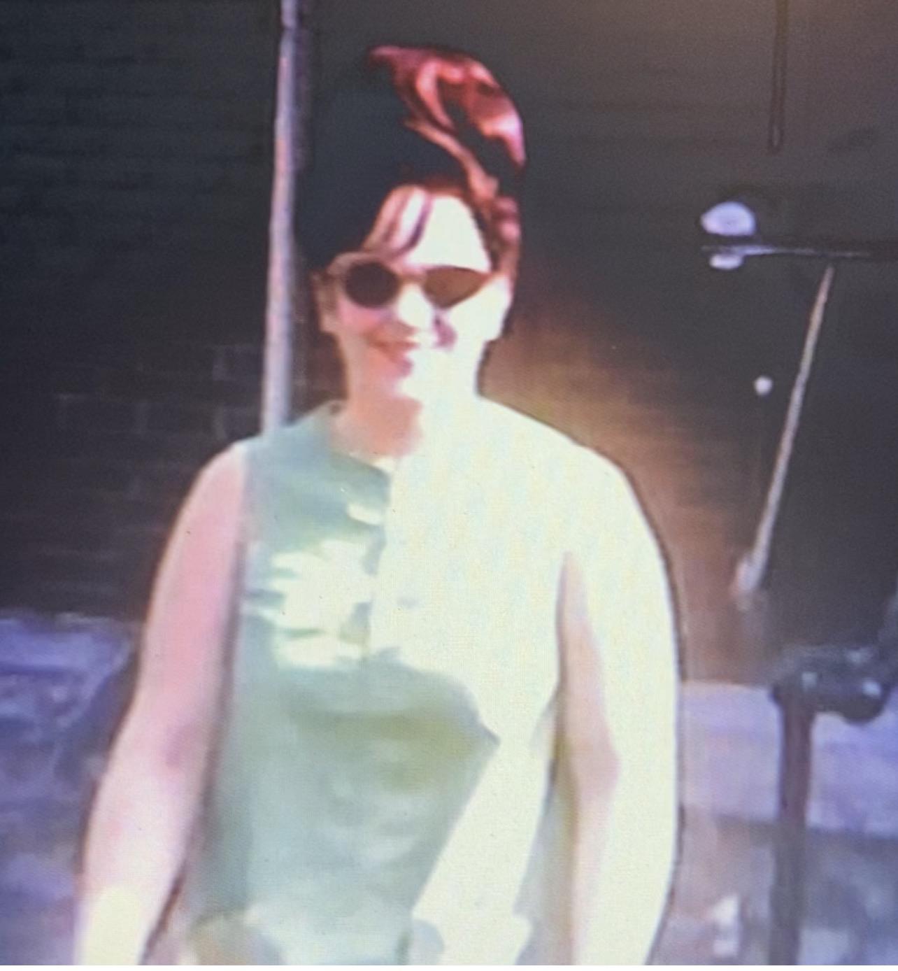 A woman wearing sunglasses and standing on stage