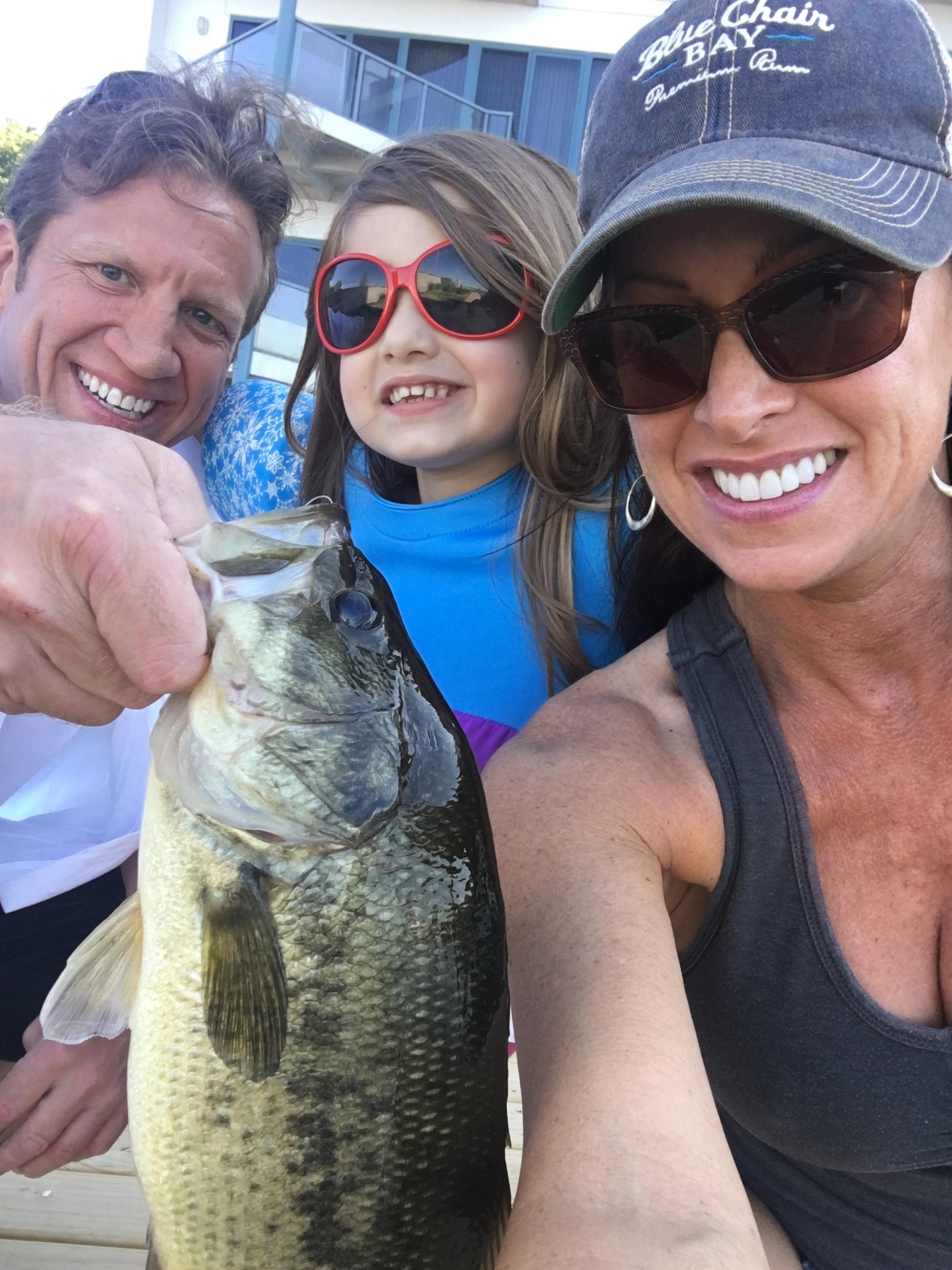 A group of people holding a fish