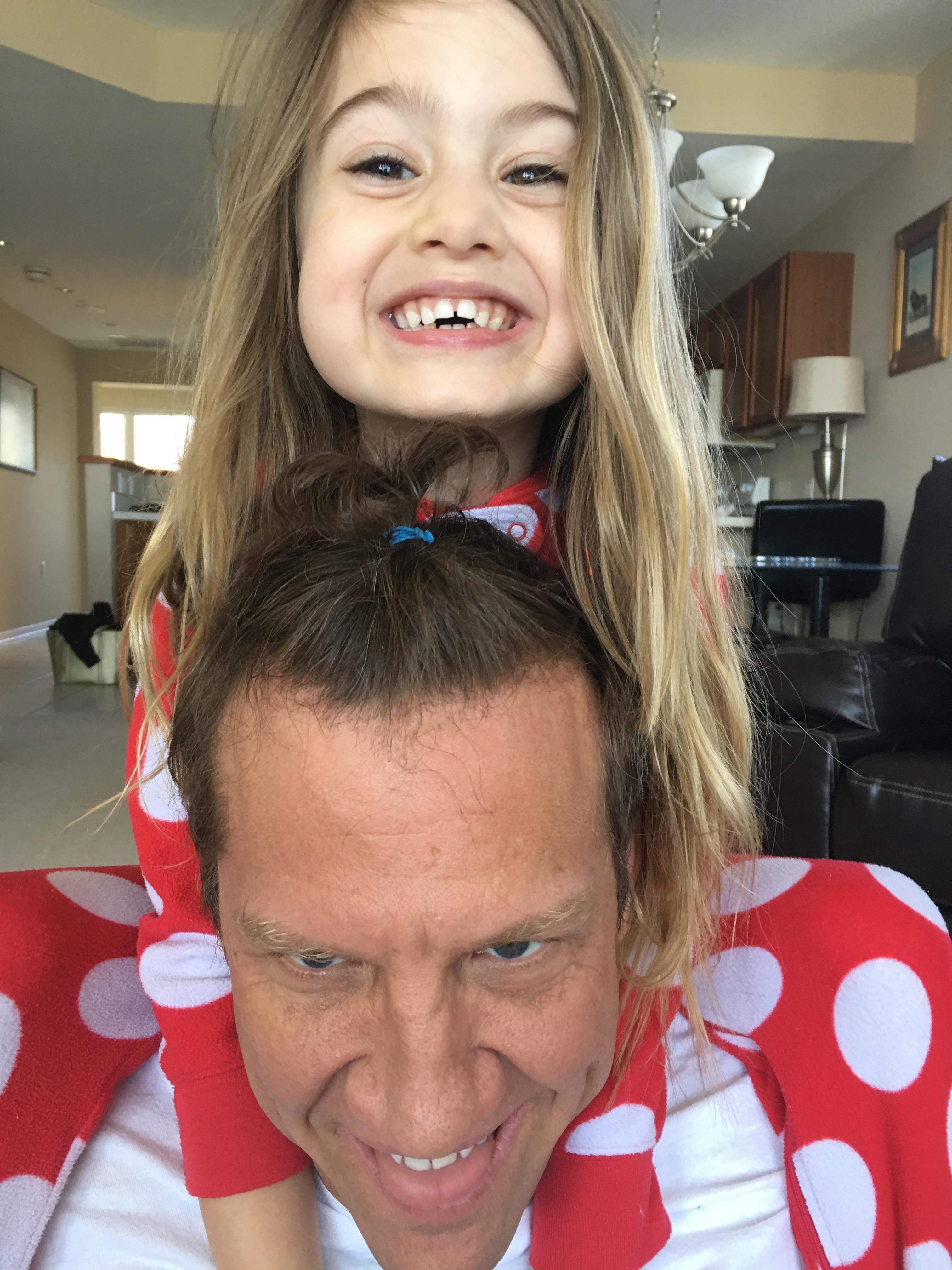 A girl sitting on a man's shoulders
