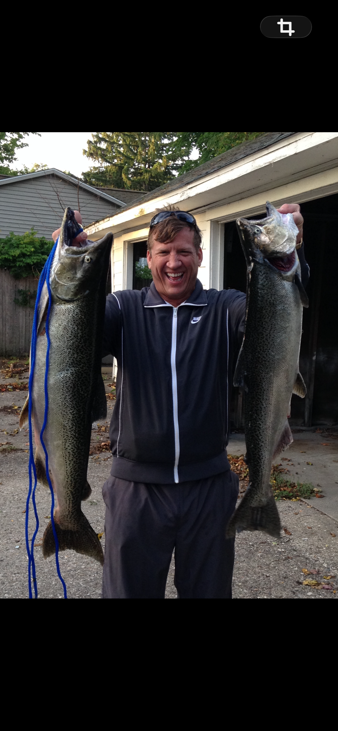 A man holding two fish