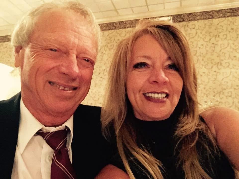 A man and woman smiling for a selfie