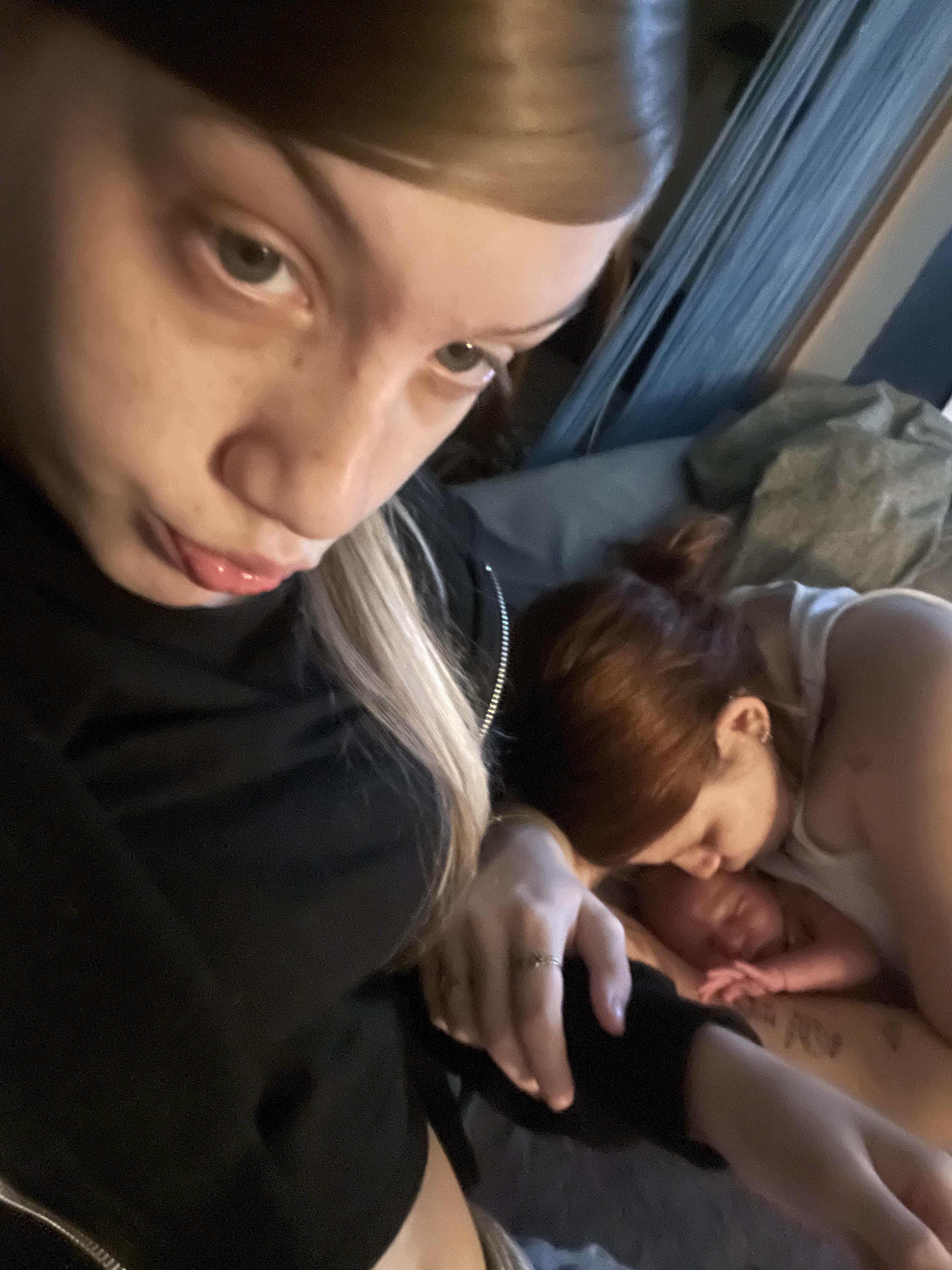A woman taking a selfie with a baby