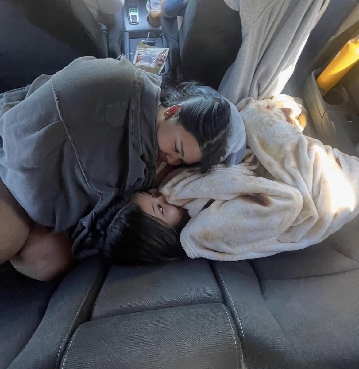 A woman sleeping in a car