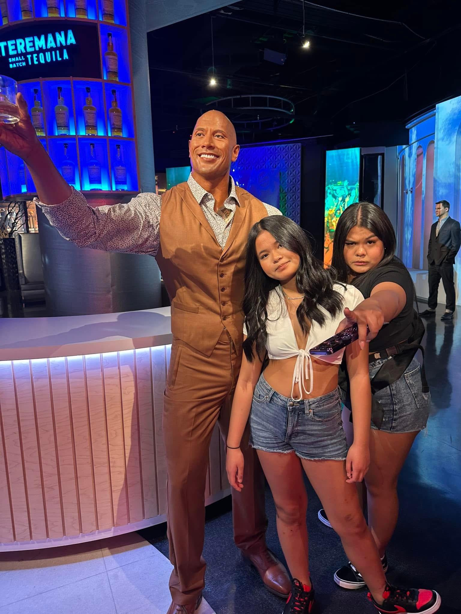 A man standing next to a couple of girls