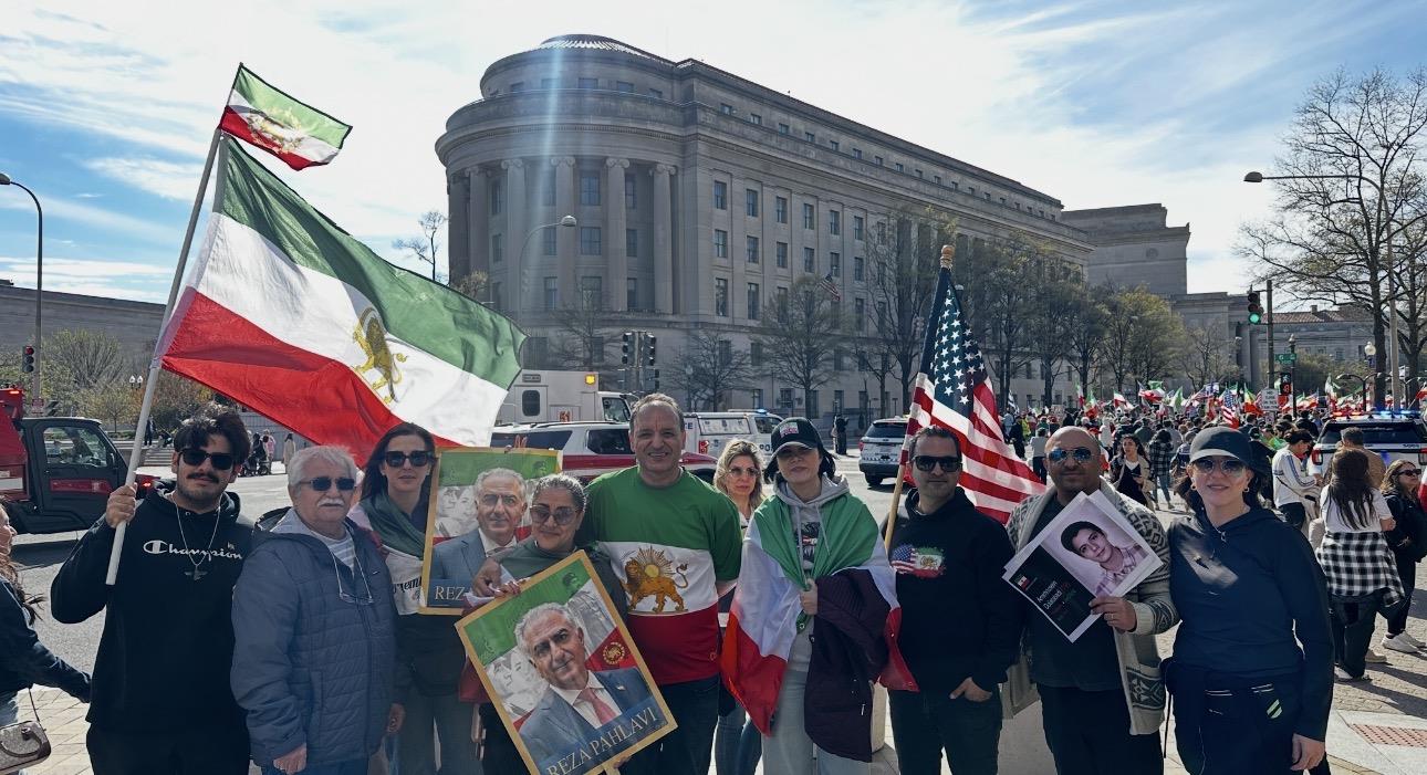 A group of people holding flags and posing for a photo
