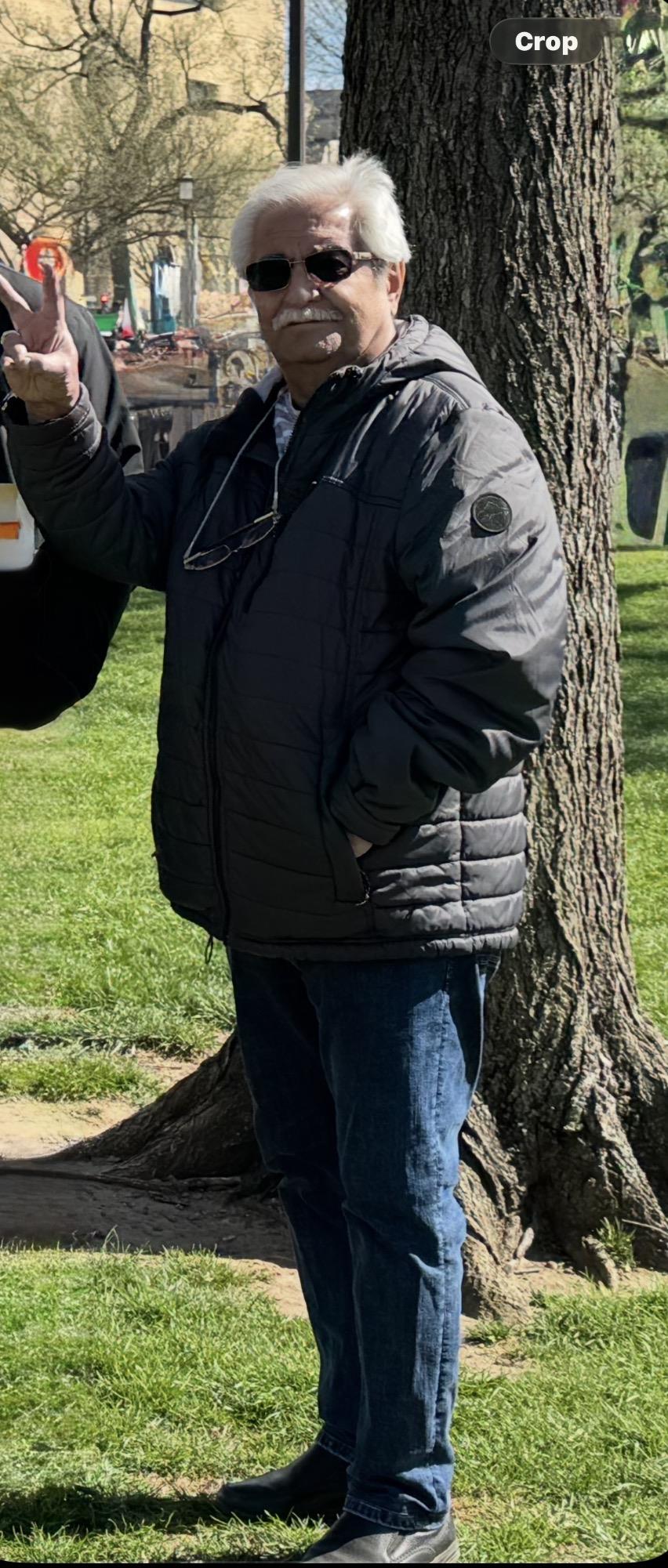 A man standing next to a tree