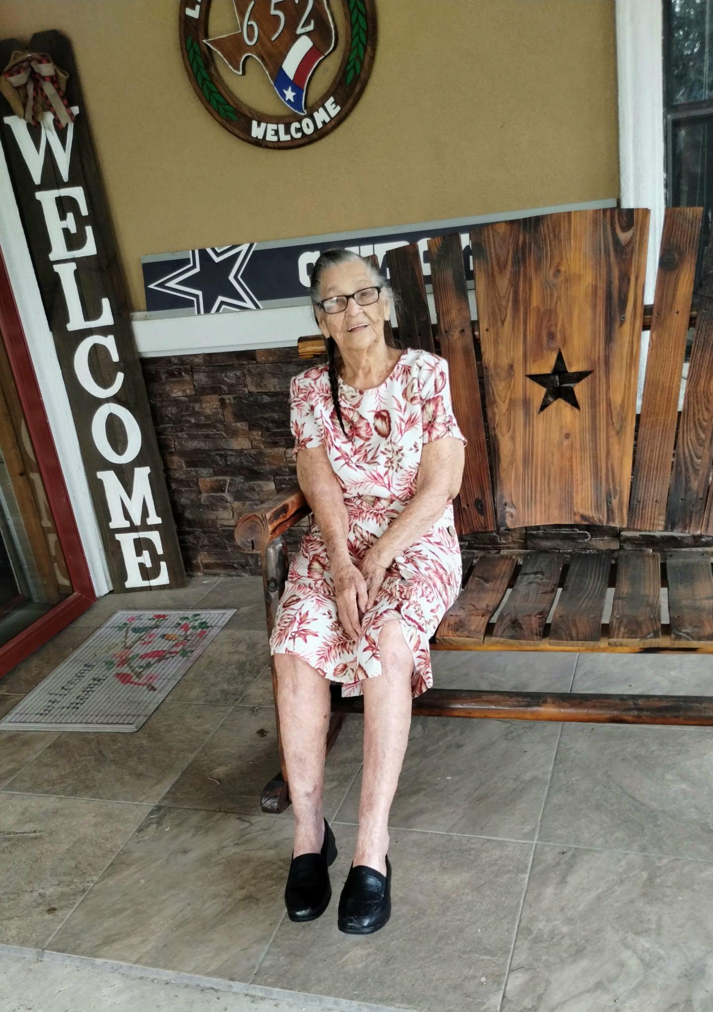 An old woman sitting on a bench