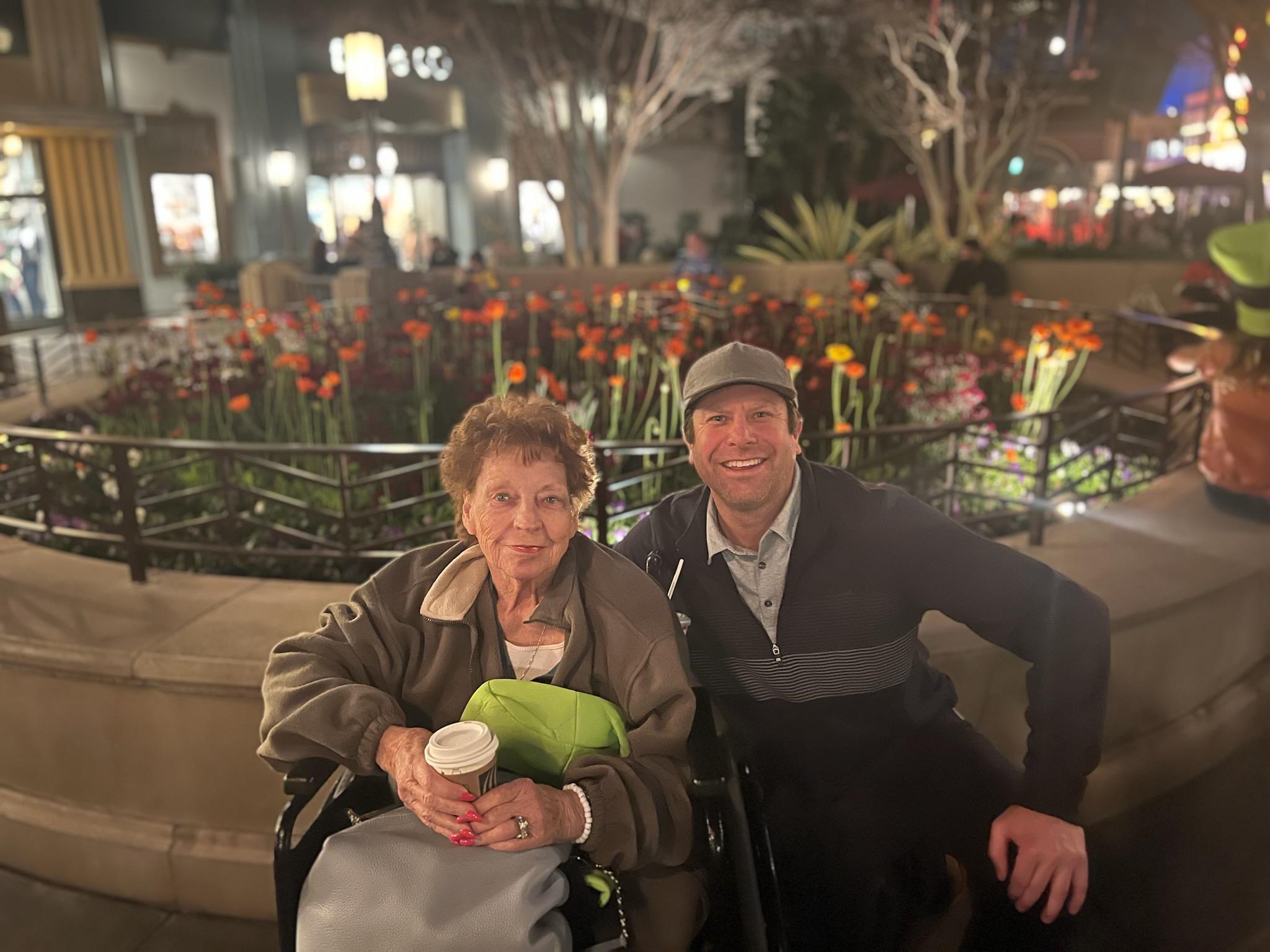 A man and woman sitting in a wheelchair