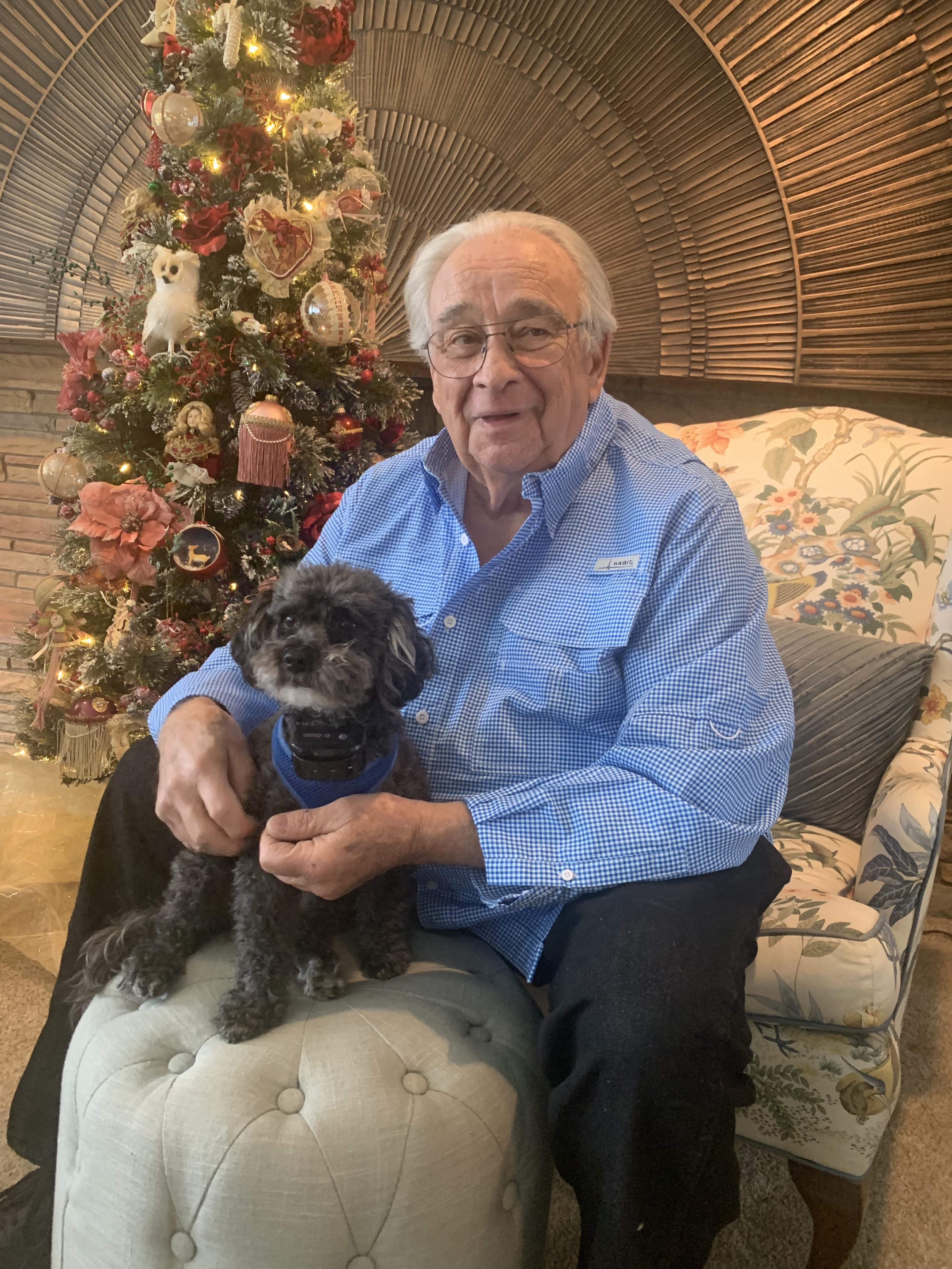 A man sitting on a chair with a dog