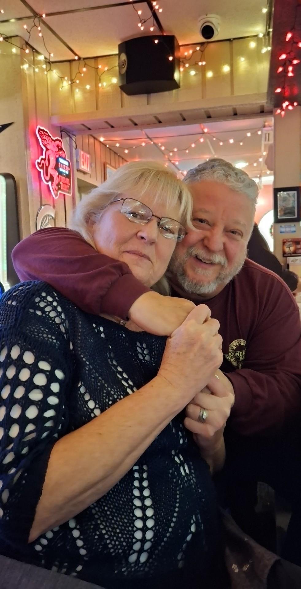A man and woman hugging each other
