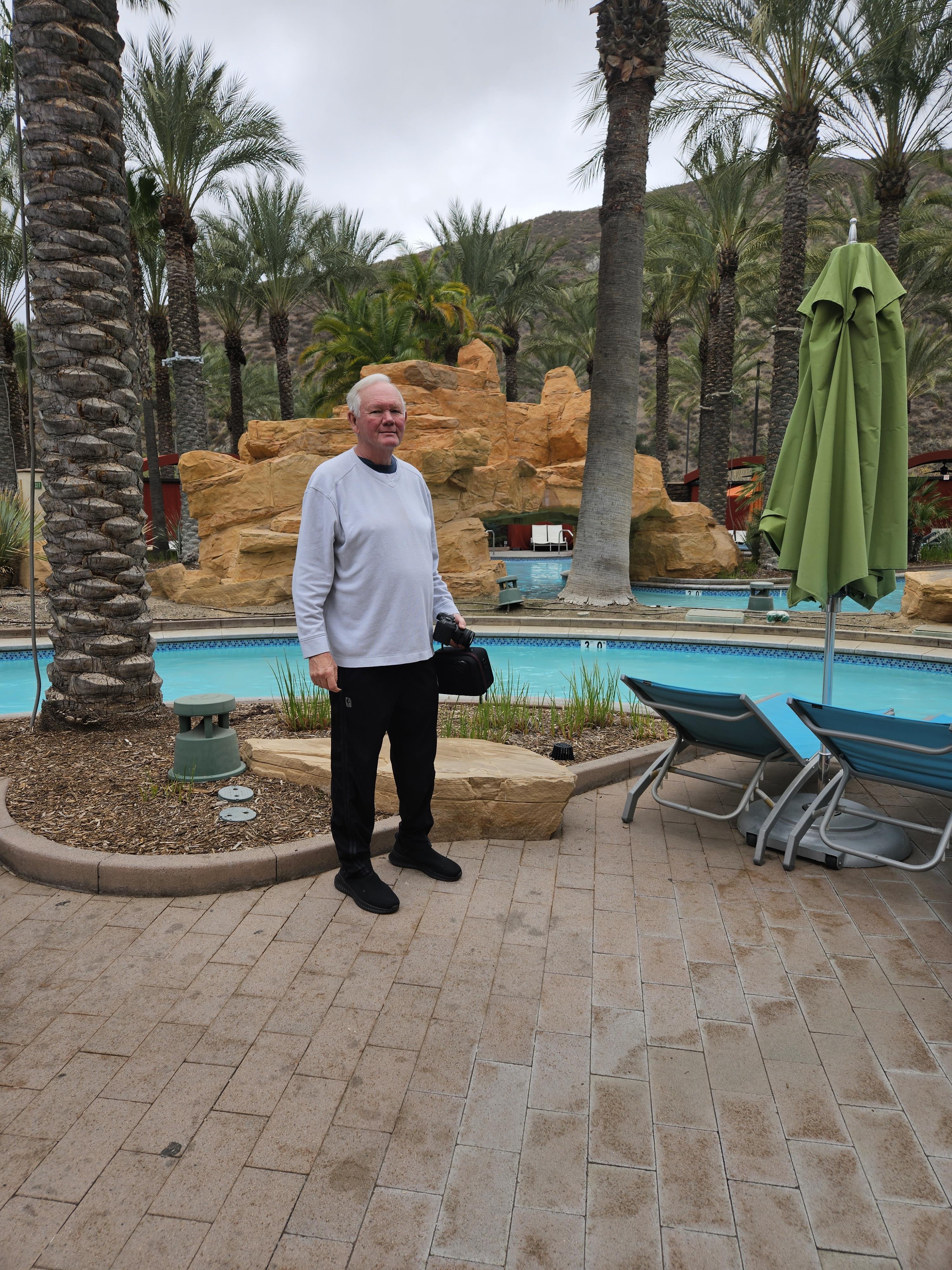 A man standing in front of a pool