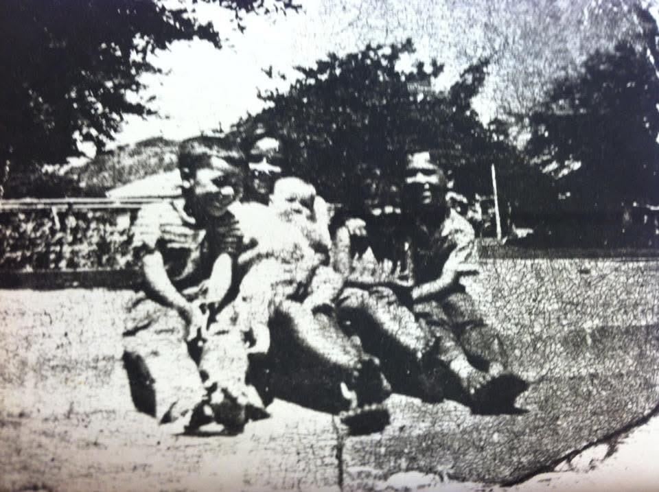 A group of children sitting on the ground