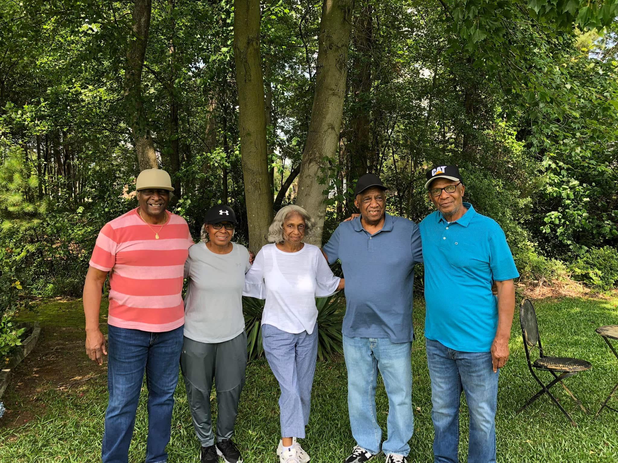 A group of people standing together in a park
