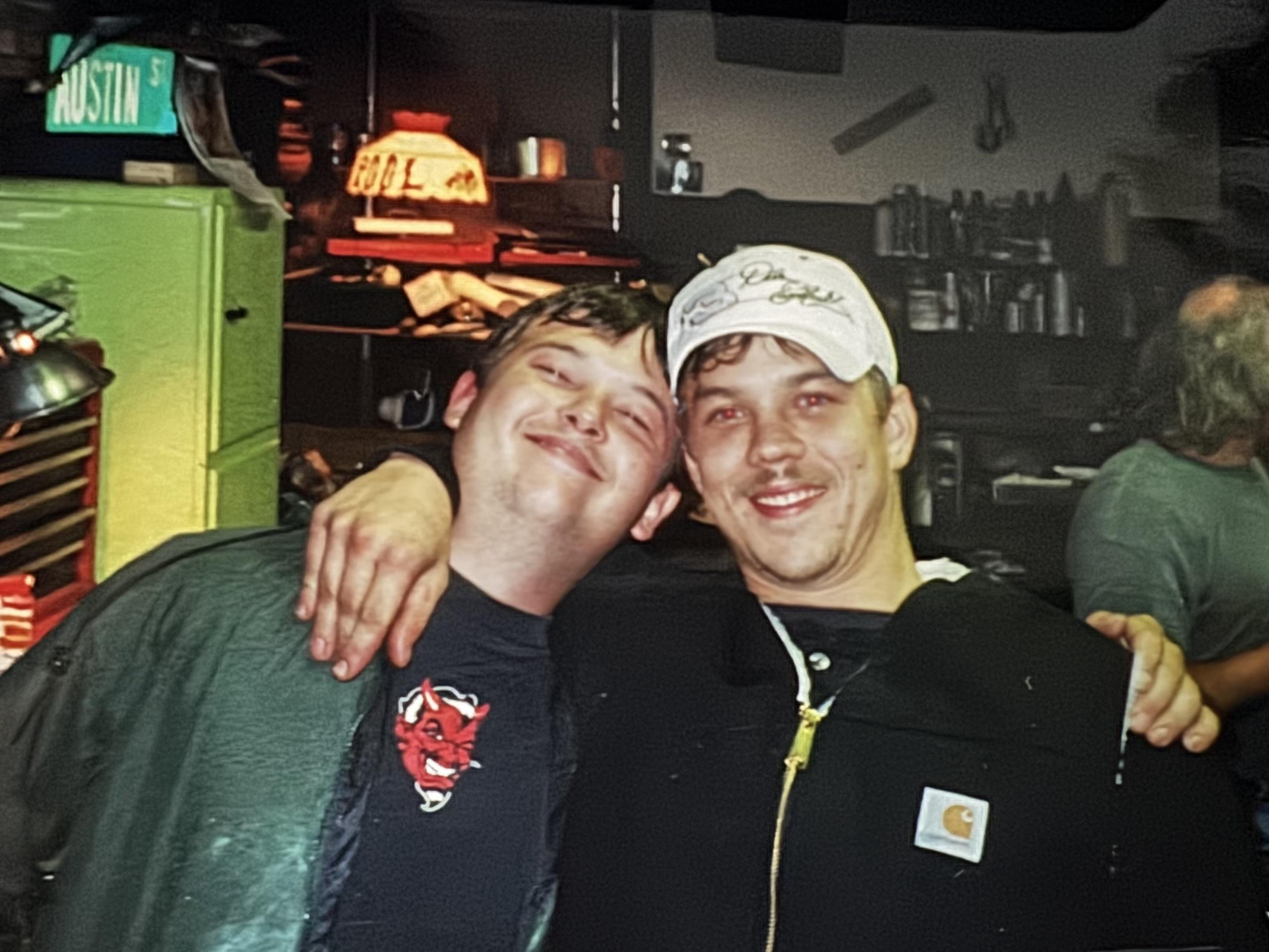Two men smiling at the camera