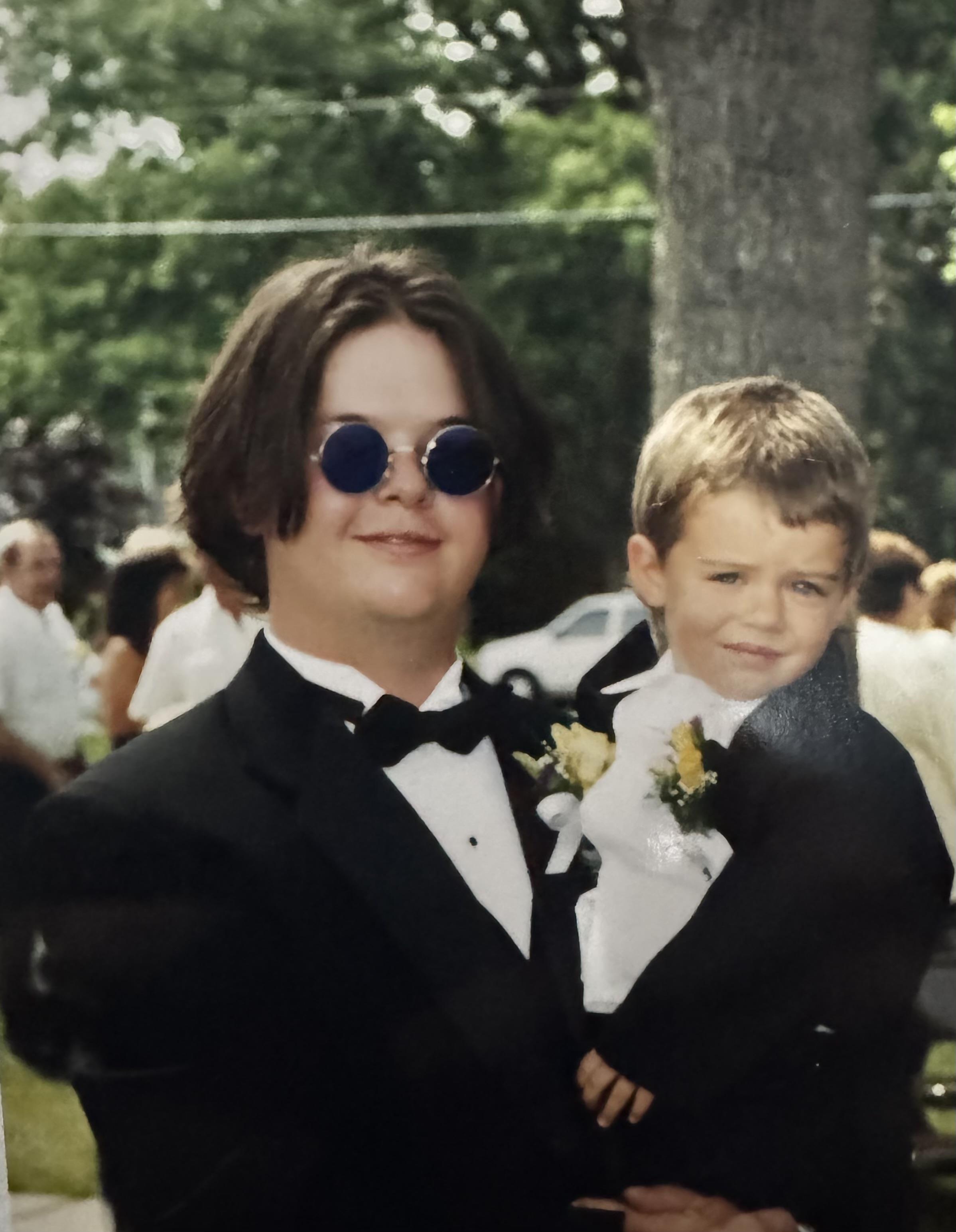 A man in a suit holding a boy