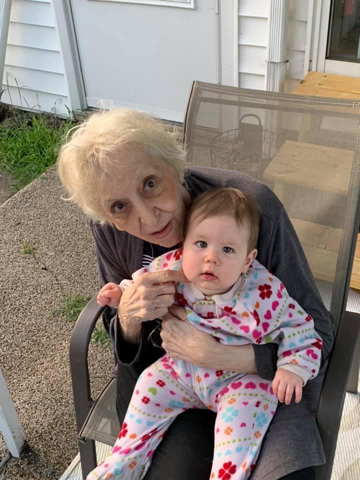 An older woman holding a baby