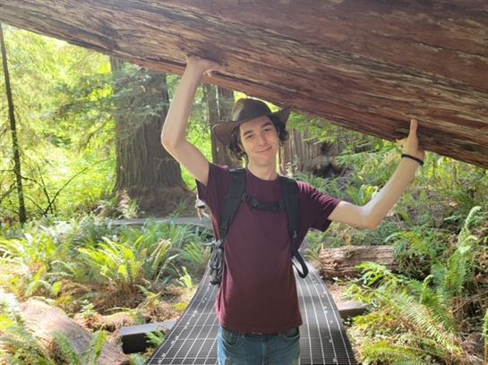 A man holding a large log