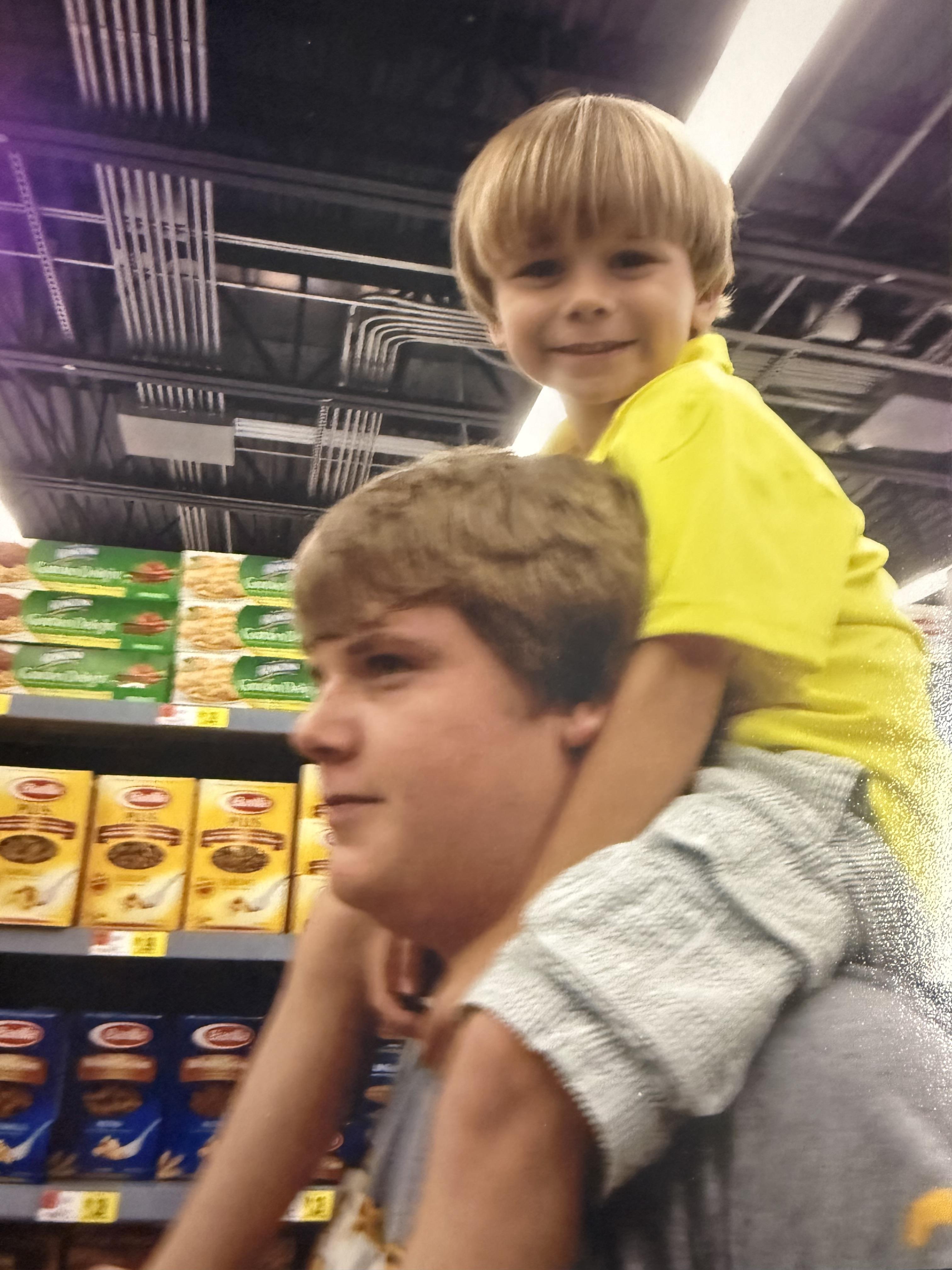A boy sitting on a man's back