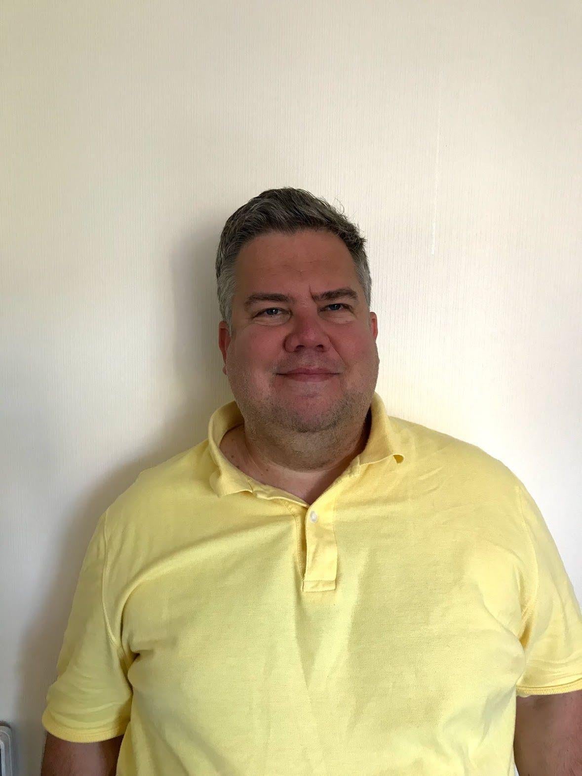 A man in a yellow shirt