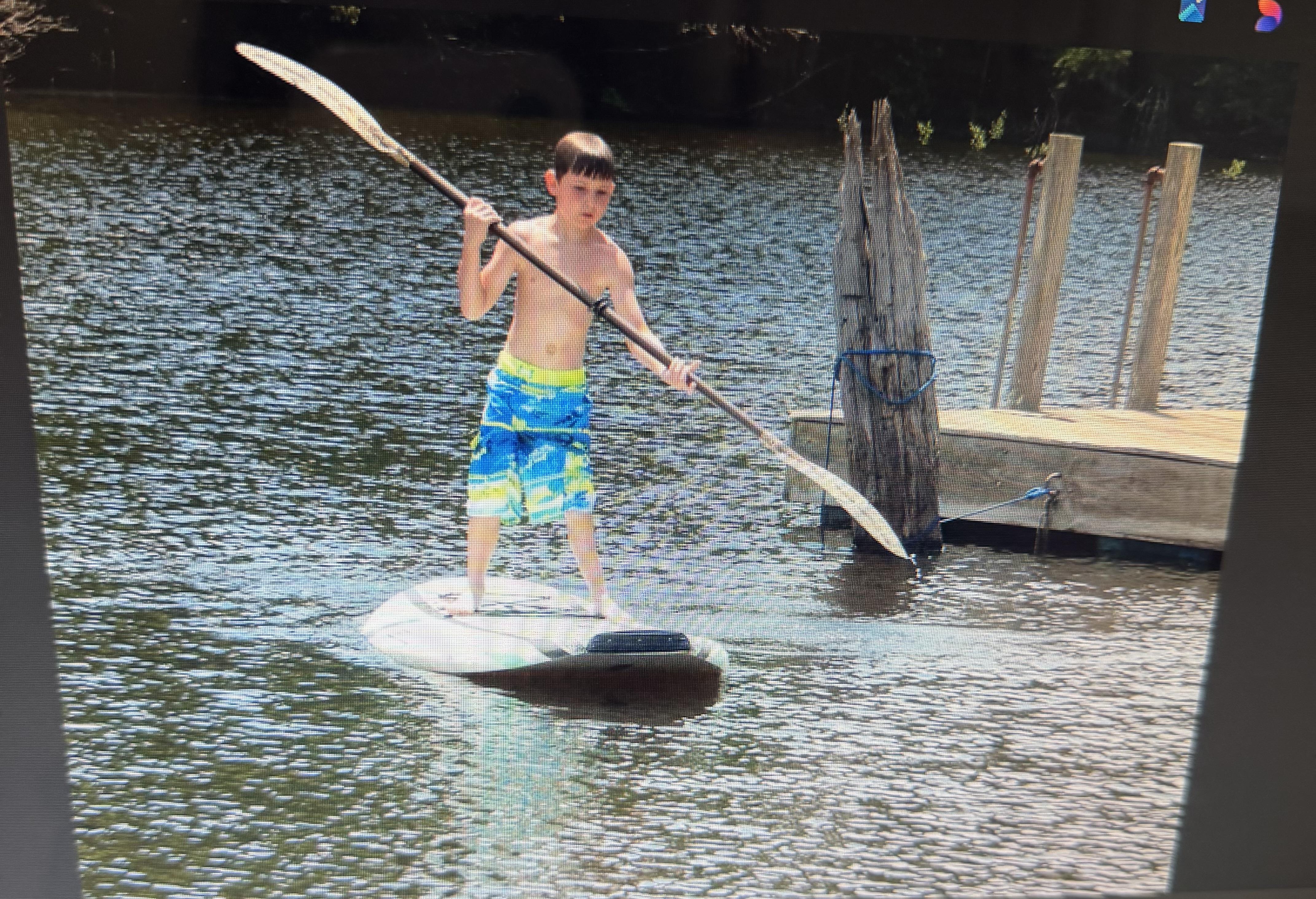 A boy on a paddle board