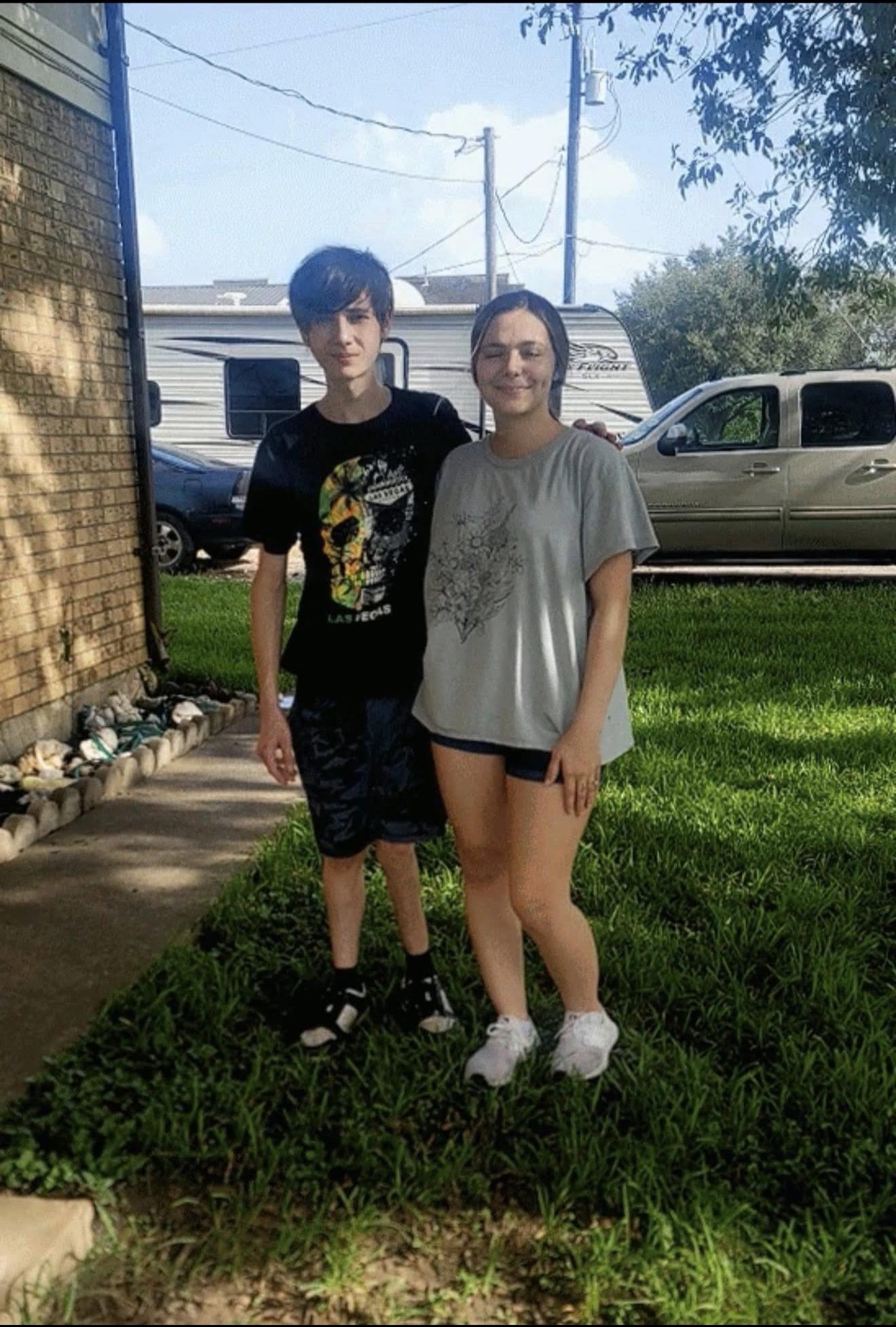 A man and woman standing in a yard
